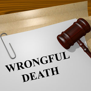 Document titled "Wrongful Death Lawsuit" on a wooden desk, with a gavel nearby - Gertler Law Firm