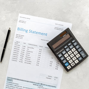 Personal Injury Claim Billing Statement with a calculator and pen - Gertler Law Firm.